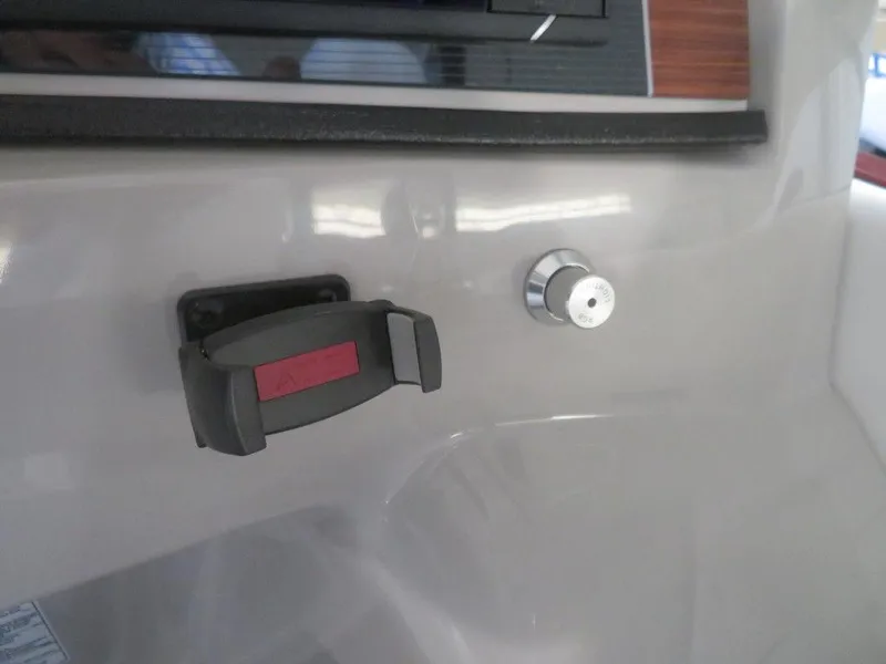 Slide: The Image of 2023 Starcraft SX 25 Q boat dashboard with control knob and switch. - 24