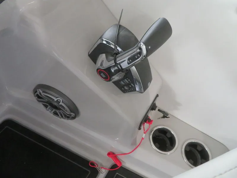 Slide: The Image of 2023 Starcraft SX 25 Q boat control panel with throttle and cup holders. - 28