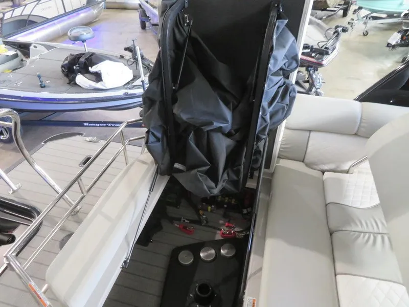 Slide: The Image of 2023 Starcraft SX 25 Q boat interior with storage compartment open. - 29