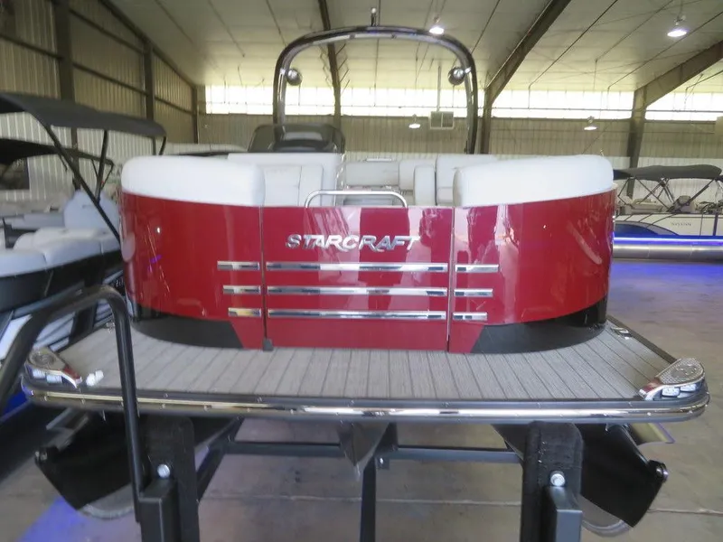 Slide: The Image of 2023 Starcraft SX 25 Q pontoon boat in a showroom. - 3
