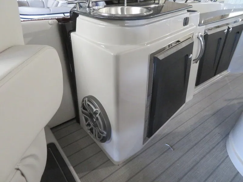Slide: The Image of 2023 Starcraft SX 25 Q boat interior with sink and storage compartments. - 30
