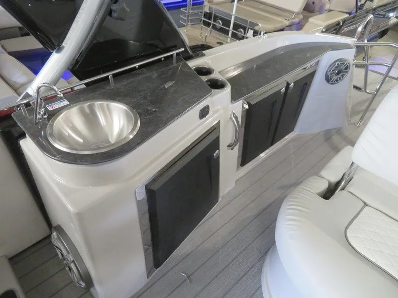 Slide: The Image of 2023 Starcraft SX 25 Q boat interior with sink and storage cabinets. - 31