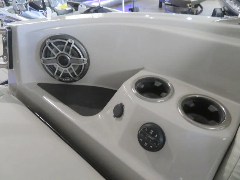 Slide: The Image of 2023 Starcraft SX 25 Q boat interior with speaker, cup holders, and control panel. - 32