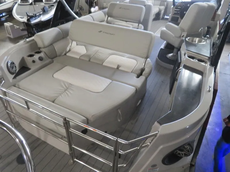 Slide: The Image of 2023 Starcraft SX 25 Q boat interior with plush seating and modern amenities. - 34