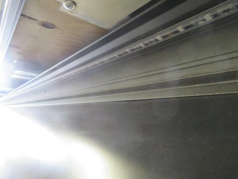 Slide: The Image of Close-up of 2023 Starcraft SX 25 Q boat's sleek metallic surface and trim. - 36