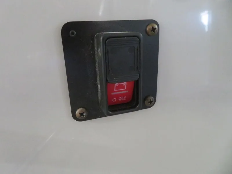 Slide: The Image of 2023 Starcraft SX 25 Q boat switch panel with red toggle switch. - 37