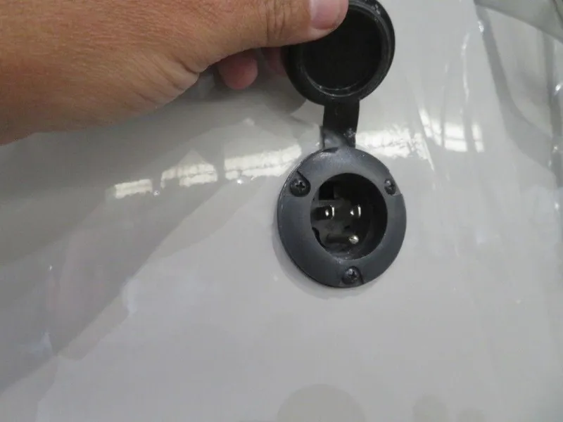Slide: The Image of Close-up of a 2023 Starcraft SX 25 Q boat's electrical outlet. - 4