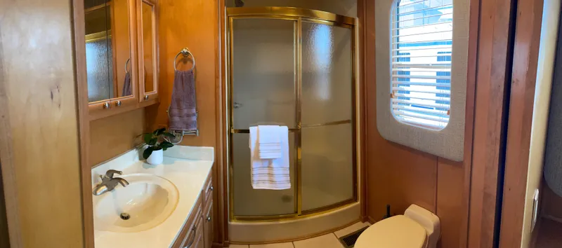Slide: The Image of 2002 Stardust Cruisers houseboat bathroom with shower, sink, and toilet. - 12