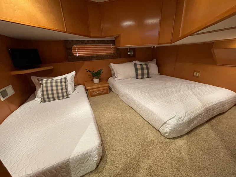 Slide: The Image of Cozy bedroom in a 2002 Stardust Cruisers houseboat with twin and double beds. - 15