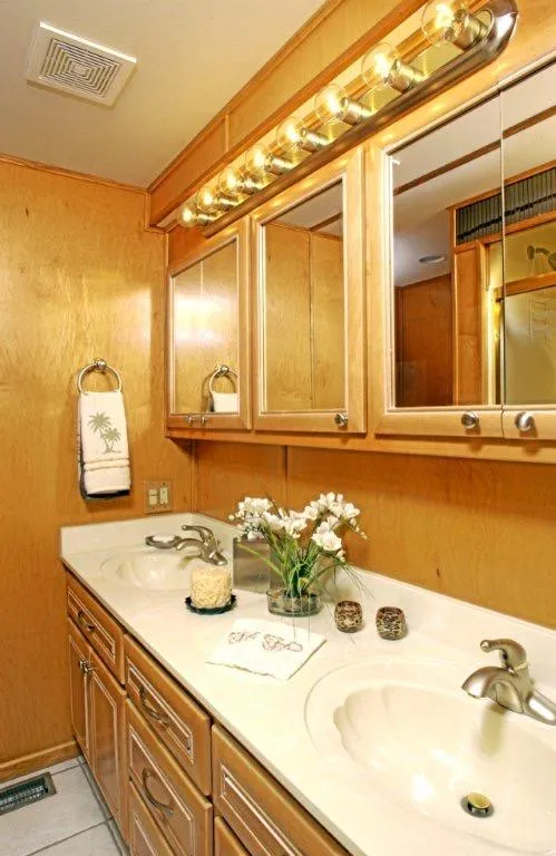 Slide: The Image of 2002 Stardust Cruisers houseboat bathroom with double sinks and wooden cabinetry. - 17