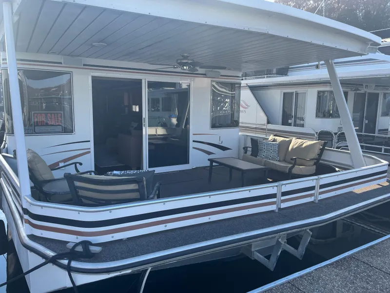 Slide: The Image of 2002 Stardust Cruisers houseboat with spacious deck and outdoor seating. - 2