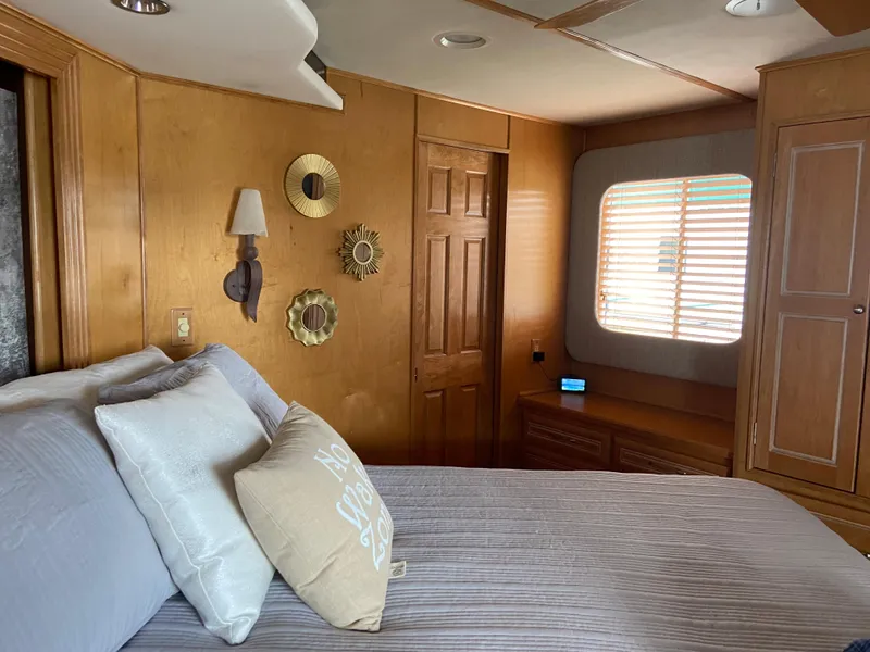 Slide: The Image of Cozy bedroom in a 2002 Stardust Cruisers houseboat with wooden decor and natural light. - 20