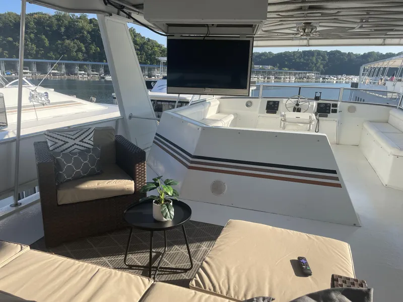 Slide: The Image of 2002 Stardust Cruisers houseboat with outdoor seating, TV, and scenic marina view. - 27