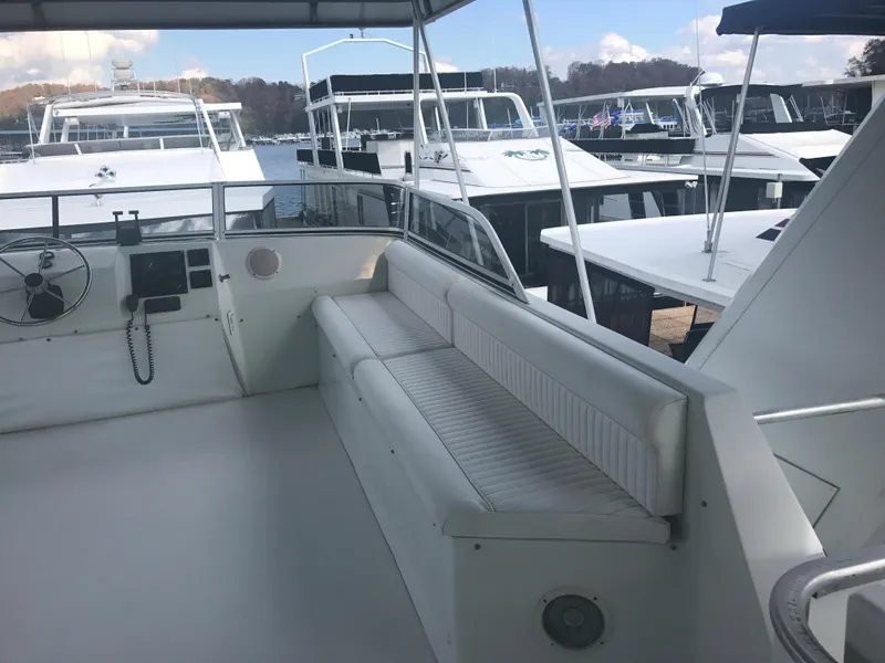 Slide: The Image of 2002 Stardust Cruisers Houseboat interior with white seating and control panel. - 31