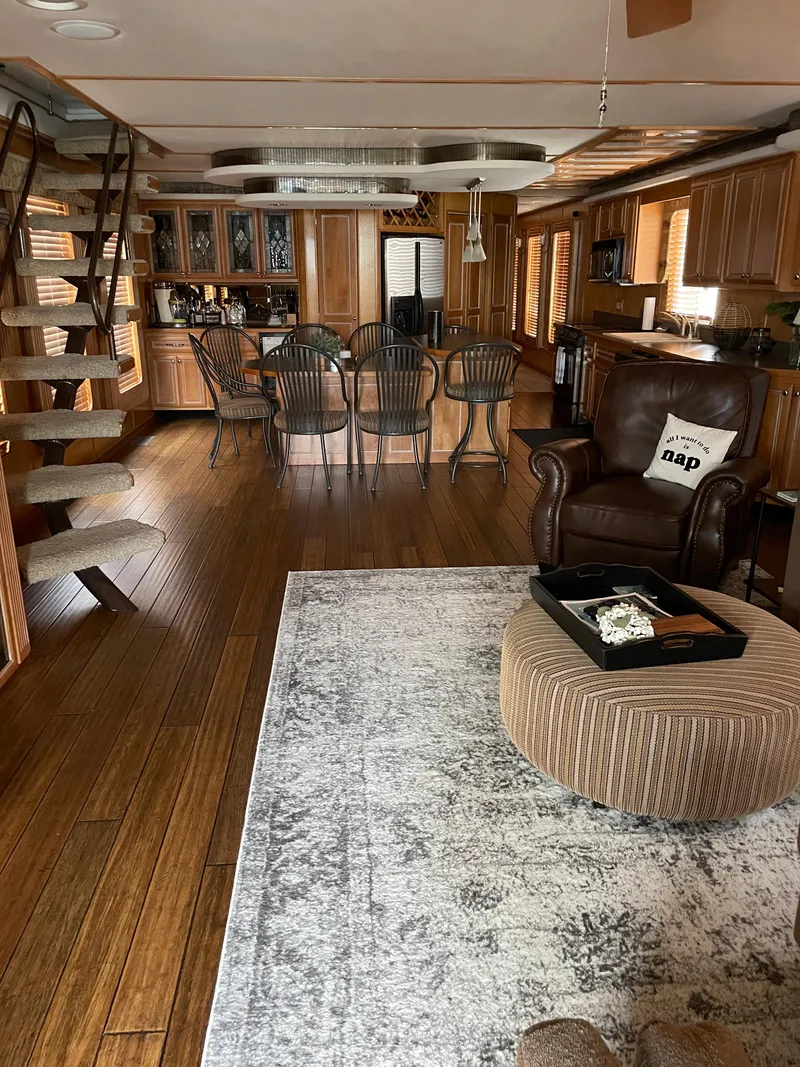 Slide: The Image of Interior of a 2002 Stardust Cruisers houseboat with modern furnishings and wooden flooring. - 4
