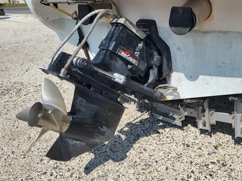 Slide: The Image of 1997 Donzi 22ZX boat with MerCruiser outdrive and propeller on a gravel surface. - 13