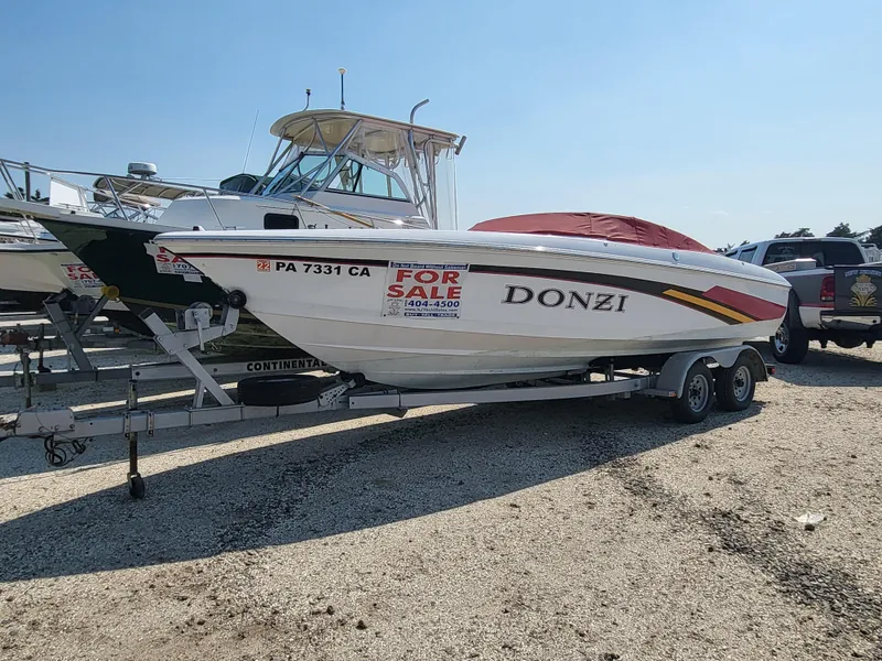 Slide: The Image of 1997 Donzi 22ZX boat on trailer, for sale, parked in a marina. - 18