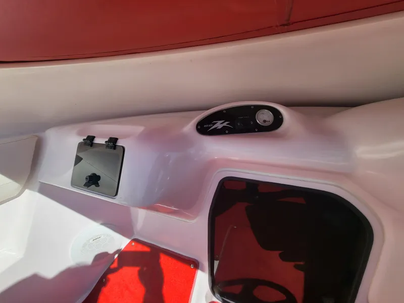 Slide: The Image of Interior view of a 1997 Donzi 22ZX boat, featuring red and white design elements. - 19