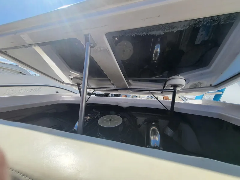 Slide: The Image of 1997 Donzi 22ZX boat engine compartment with open hatch, showcasing engine details. - 21