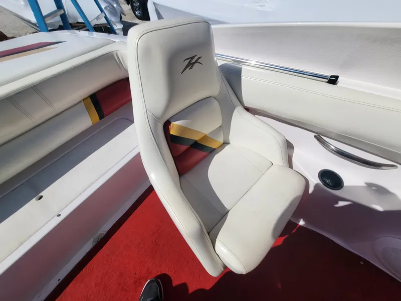 Slide: The Image of 1997 Donzi 22ZX boat interior with white seat and red carpet. - 25