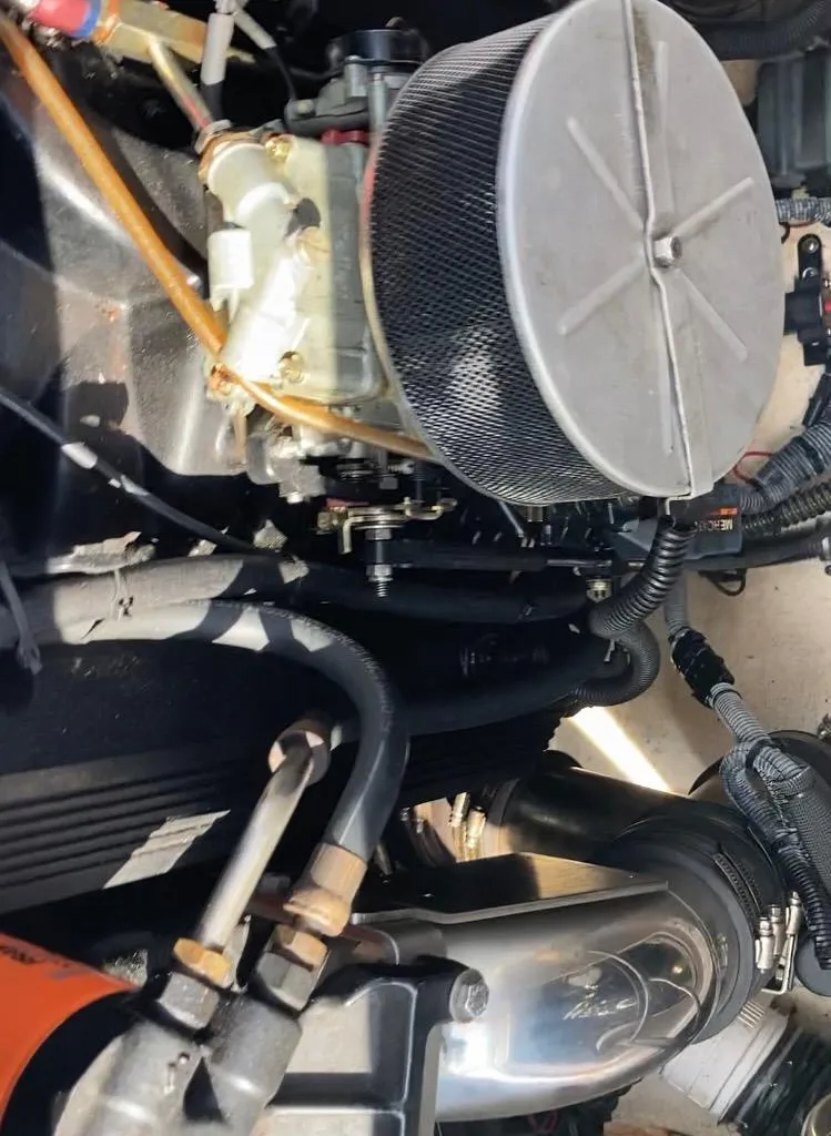 Slide: The Image of Engine components of a 1997 Donzi 22ZX boat, featuring air filter and hoses. - 9