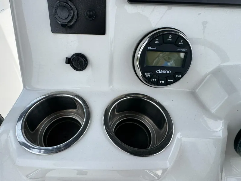 Slide: The Image of 2018 Robalo R200 Center Console dashboard with Clarion audio system and dual cup holders. - 10