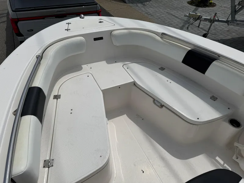 Slide: The Image of 2018 Robalo R200 Center Console boat interior with white seating and storage compartments. - 13