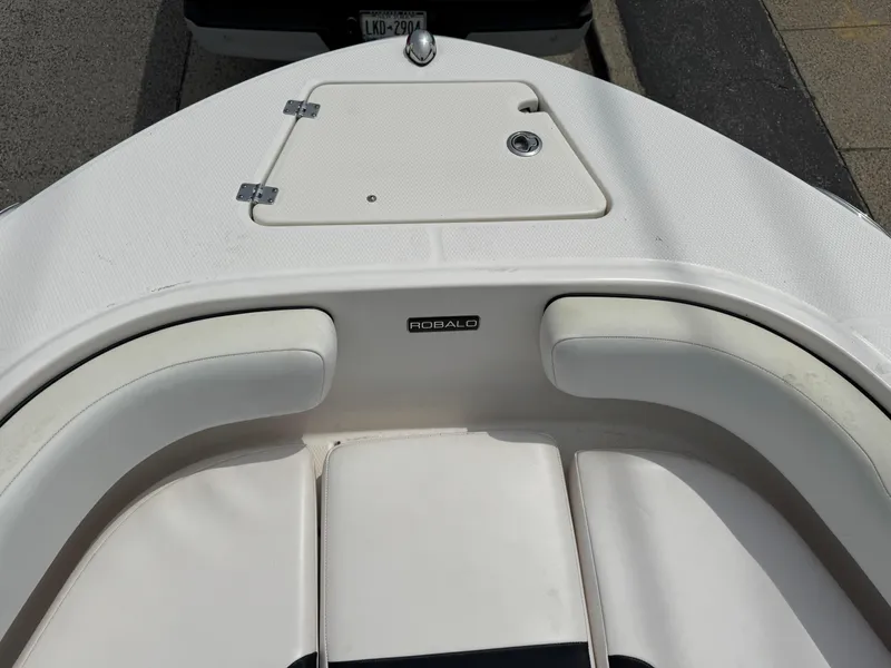 Slide: The Image of 2018 Robalo R200 Center Console boat with white seating and storage compartment. - 15