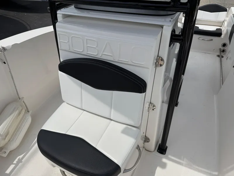 Slide: The Image of 2018 Robalo R200 Center Console boat interior with white and black seating. - 16