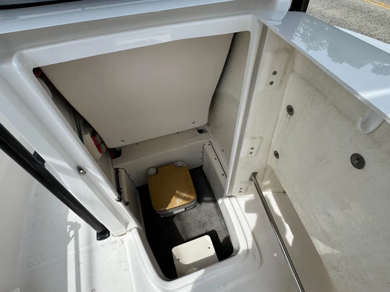 Slide: The Image of 2018 Robalo R200 Center Console storage compartment interior with clean, white finish. - 17