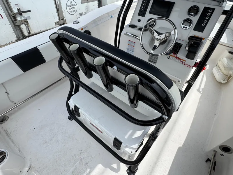 Slide: The Image of 2018 Robalo R200 Center Console boat interior with steering wheel and rod holders. - 3