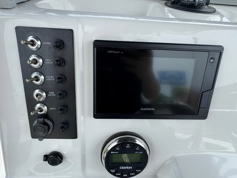 Slide: The Image of 2018 Robalo R200 Center Console dashboard with Garmin GPS and Clarion audio controls. - 7