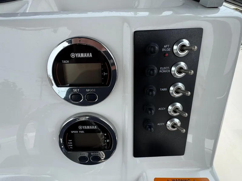 Slide: The Image of 2018 Robalo R200 Center Console dashboard with Yamaha gauges and control switches. - 8