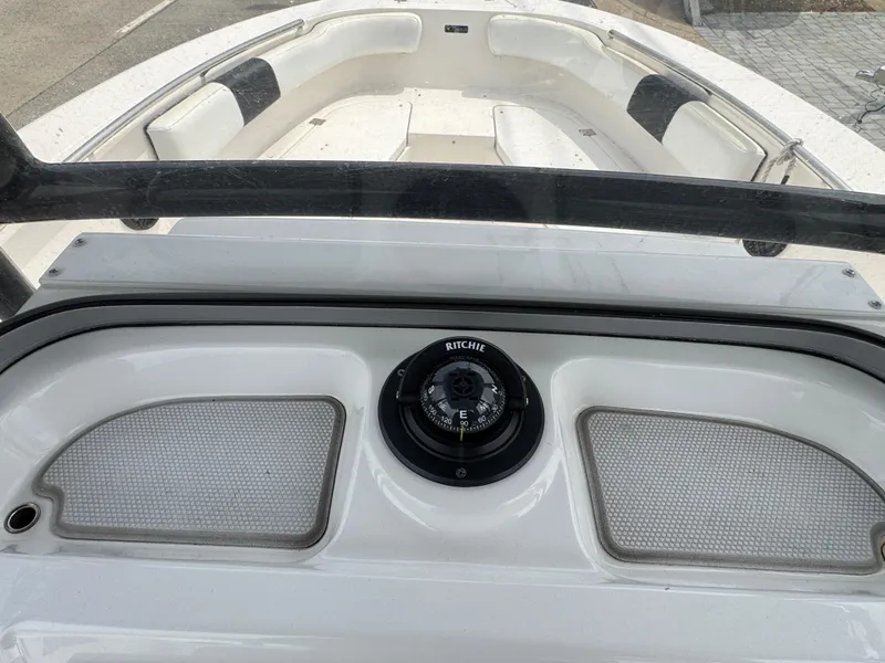 Slide: The Image of 2018 Robalo R200 Center Console boat interior with compass and seating. - 9