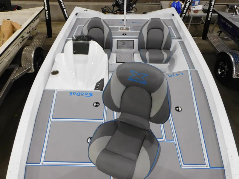Slide: The Image of 2023 Xpress H18C boat interior with gray and blue seating and deck. - 11