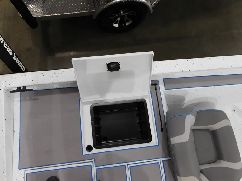 Slide: The Image of 2023 Xpress H18C boat interior with open storage compartment and seating. - 13