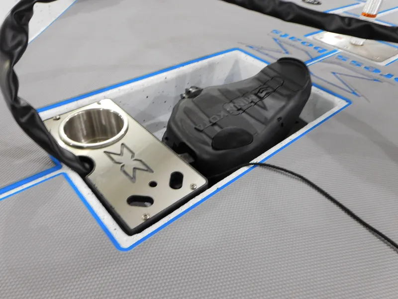 Slide: The Image of Close-up of the 2023 Xpress H18C boat's deck with cup holder and foot pedal. - 16