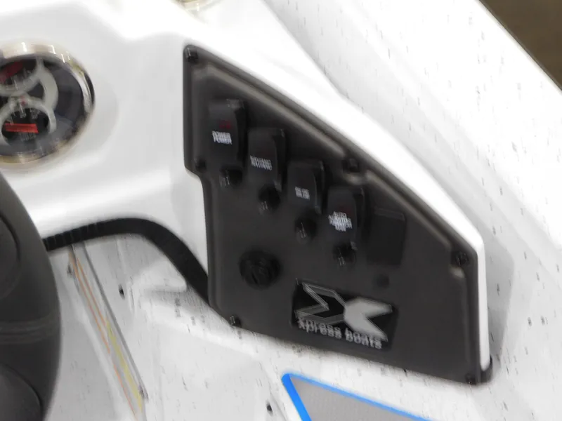 Slide: The Image of Control panel of 2023 Xpress H18C boat with switches and gauge. - 6