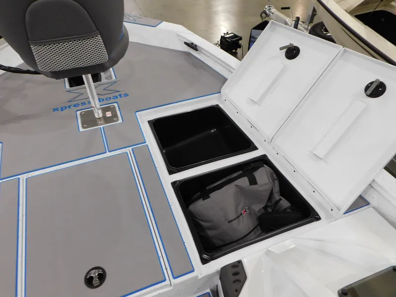 Slide: The Image of 2023 Xpress H18C boat with open storage compartments and seating. - 9