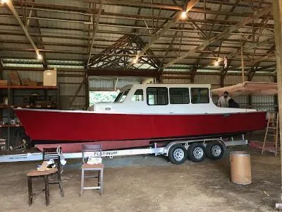 Slide: The Image of Red and white 2008 Gasparek Marine Eco Trawler on trailer in a barn. - 12