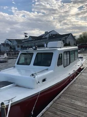 Slide: The Image of Custom 2008 Gasparek Marine Eco Trawler docked by waterfront homes under cloudy sky. - 13
