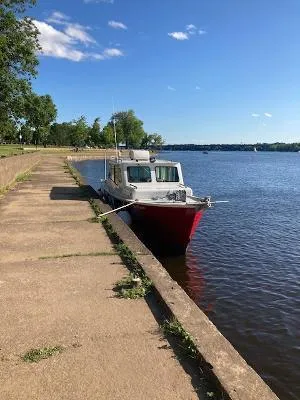 Slide: The Image of Custom Gasparek Marine Eco Trawler 2008 docked by a serene riverside walkway. - 16