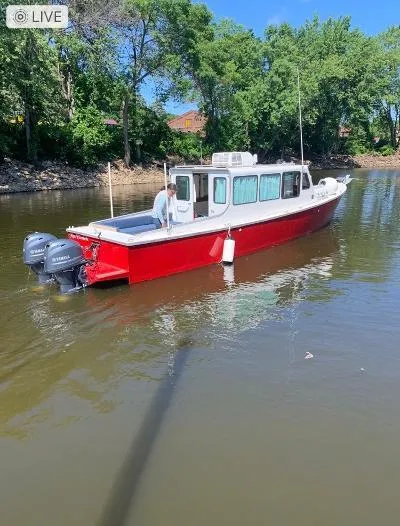 Slide: The Image of Red 2008 Gasparek Marine Eco Trawler on calm river, surrounded by trees. - 18