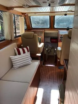 Slide: The Image of Interior of 2008 Gasparek Marine Eco Trawler with cozy seating and wooden flooring. - 9