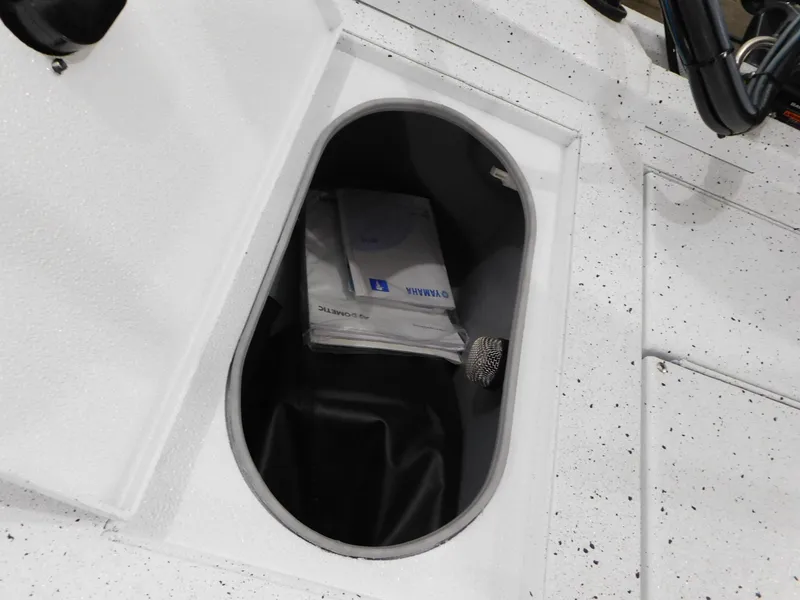 Slide: The Image of Storage compartment of 2023 Xpress H190B boat with manuals and accessories. - 11