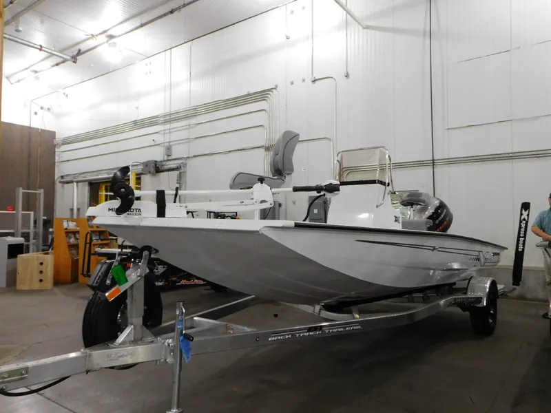 Slide: The Image of 2023 Xpress H190B boat in a warehouse, mounted on a trailer. - 18