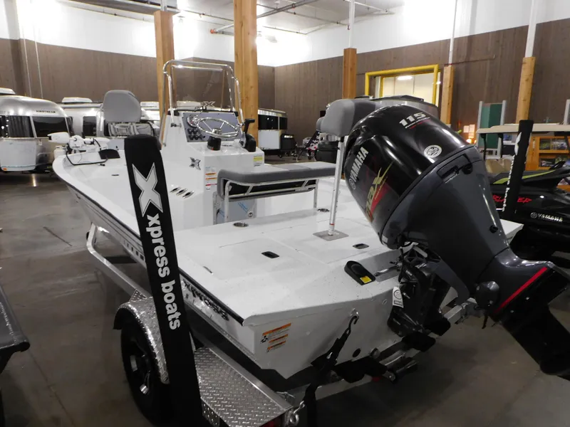 Slide: The Image of 2023 Xpress H190B boat with Yamaha 115 HP engine in showroom. - 19