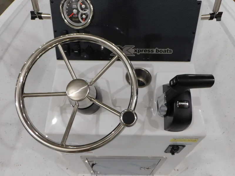 Slide: The Image of 2023 Xpress H190B boat steering console with stainless steel wheel and controls. - 23