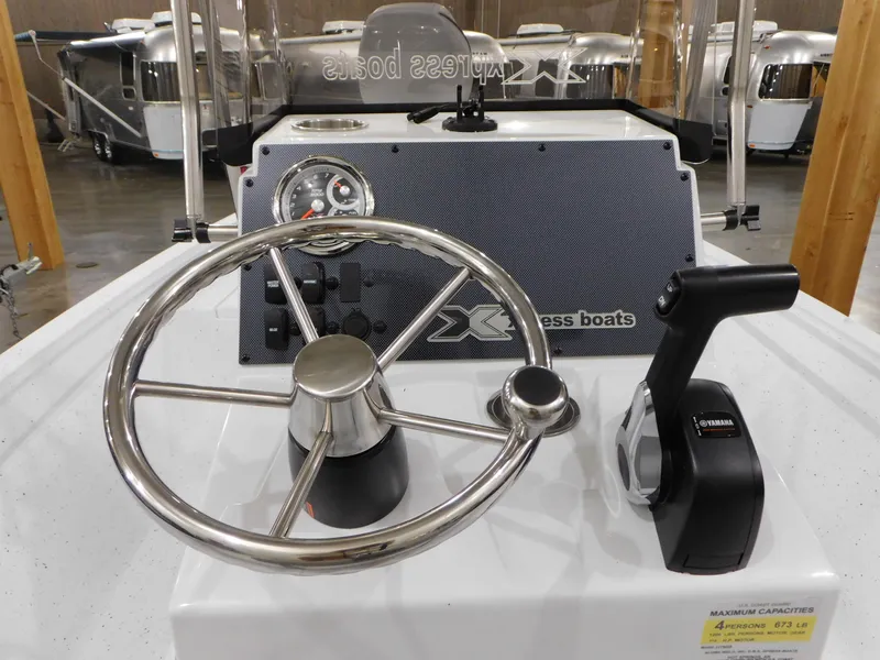 Slide: The Image of 2023 Xpress H190B boat helm with steering wheel and throttle control. - 24