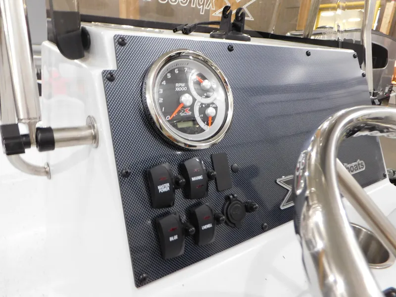 Slide: The Image of Dashboard of 2023 Xpress H190B boat with RPM gauge and control switches. - 25